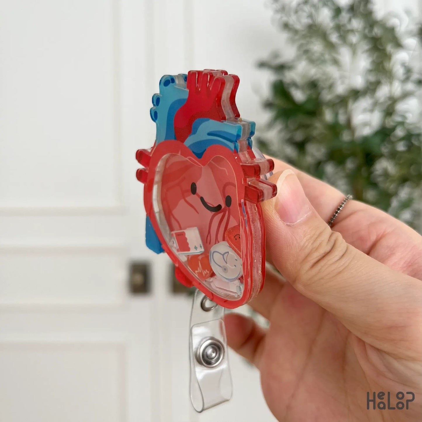 Side angle of anatomical heart shaker badge reel, durable acrylic ID clip for nurses