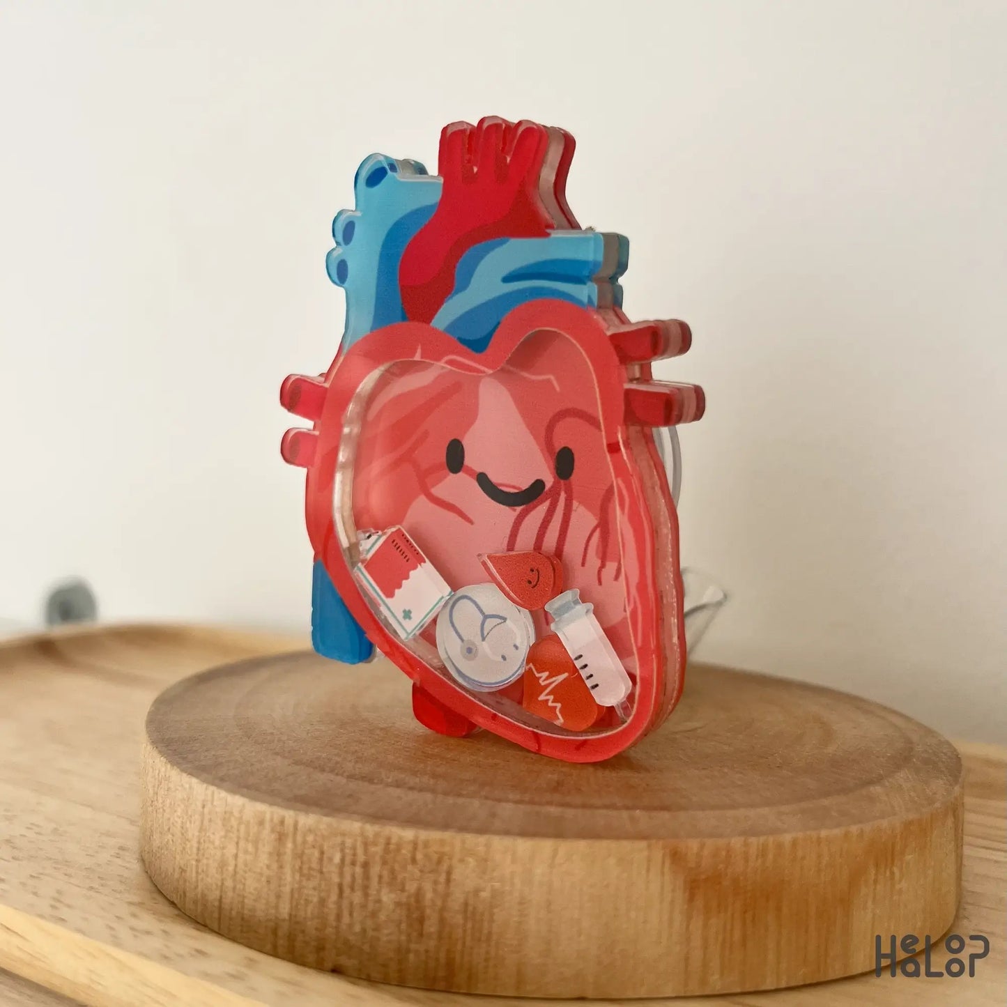 Detailed close-up of anatomical heart shaker badge reel with nurse-inspired charms