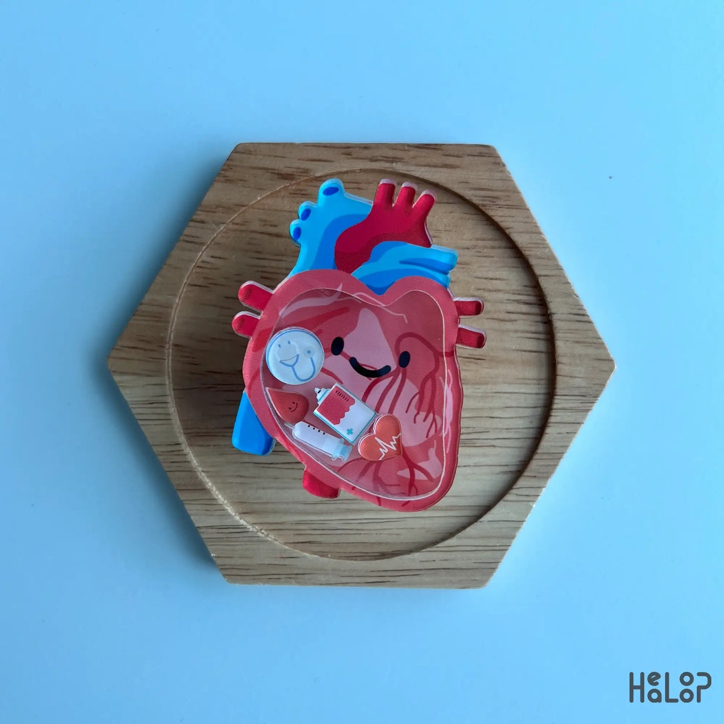 Anatomical heart shaker phone grip flat lay on wood display, kawaii medical phone accessory