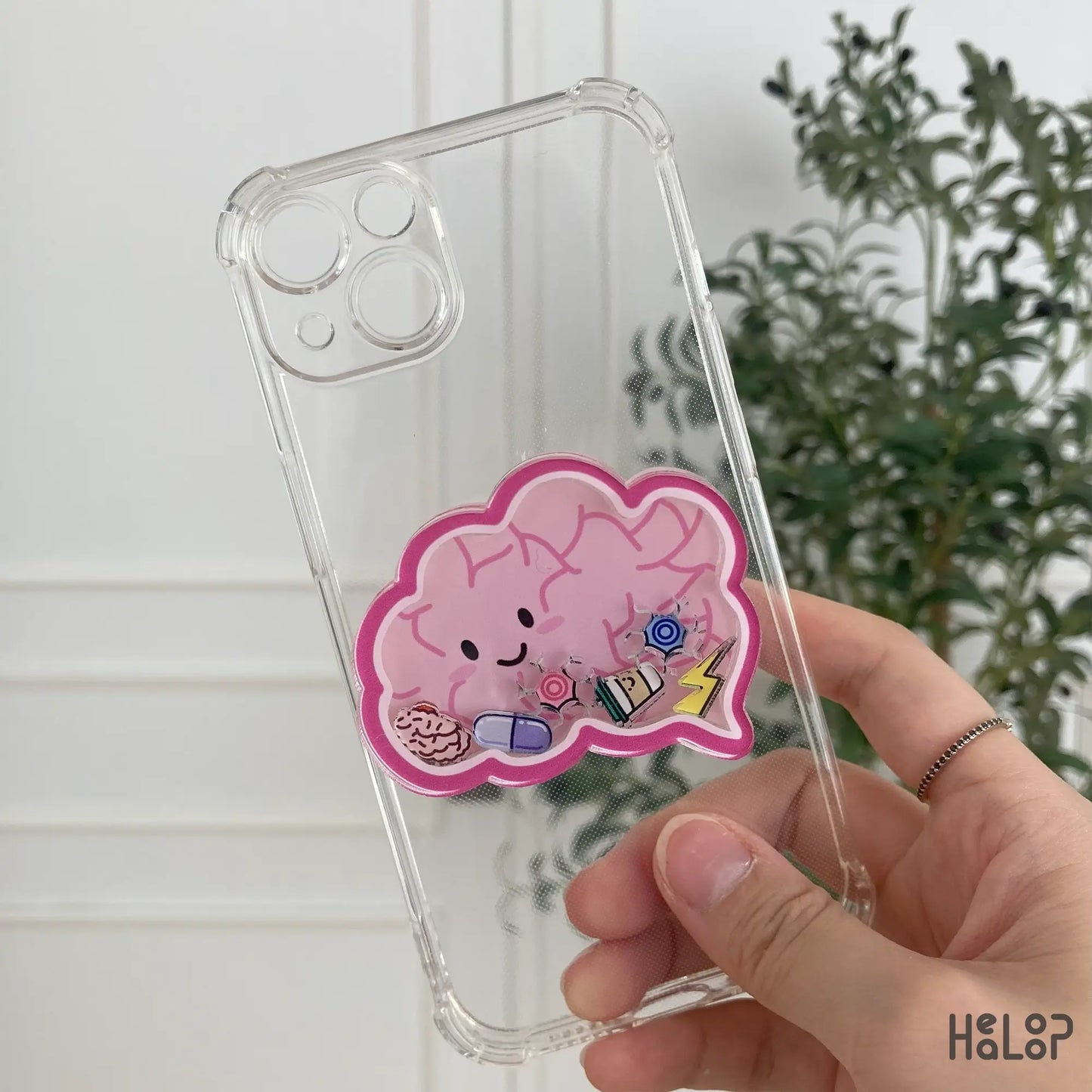 Brain-shaped shaker phone grip on transparent phone case