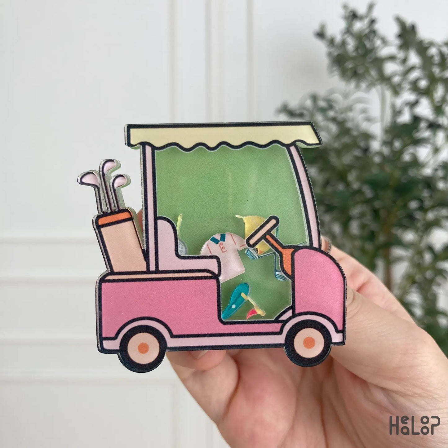 Cute pink golf cart shaker phone grip with mini golf-themed charms, front view