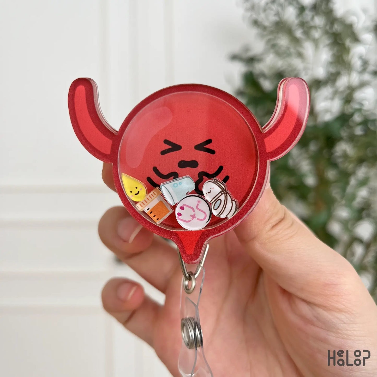 Closeup of bladder badge reel – nurse gift, shaker style with floating medical icons