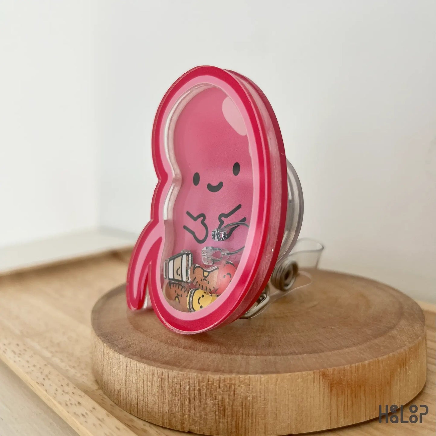 Side view showing medical shaker charms inside kidney badge reel