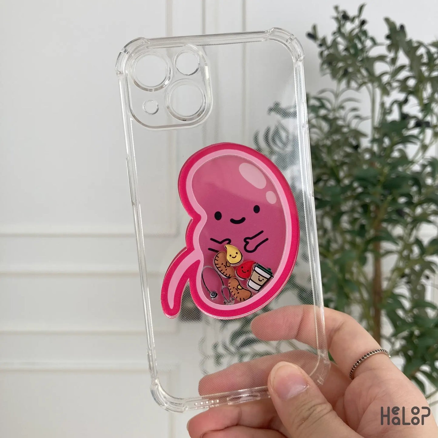 Kidney-shaped pink shaker phone grip on transparent iPhone case