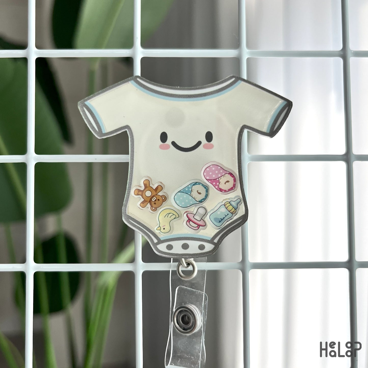 NICU baby onesie shaker badge reel displayed on wire grid, retractable ID holder for nurses