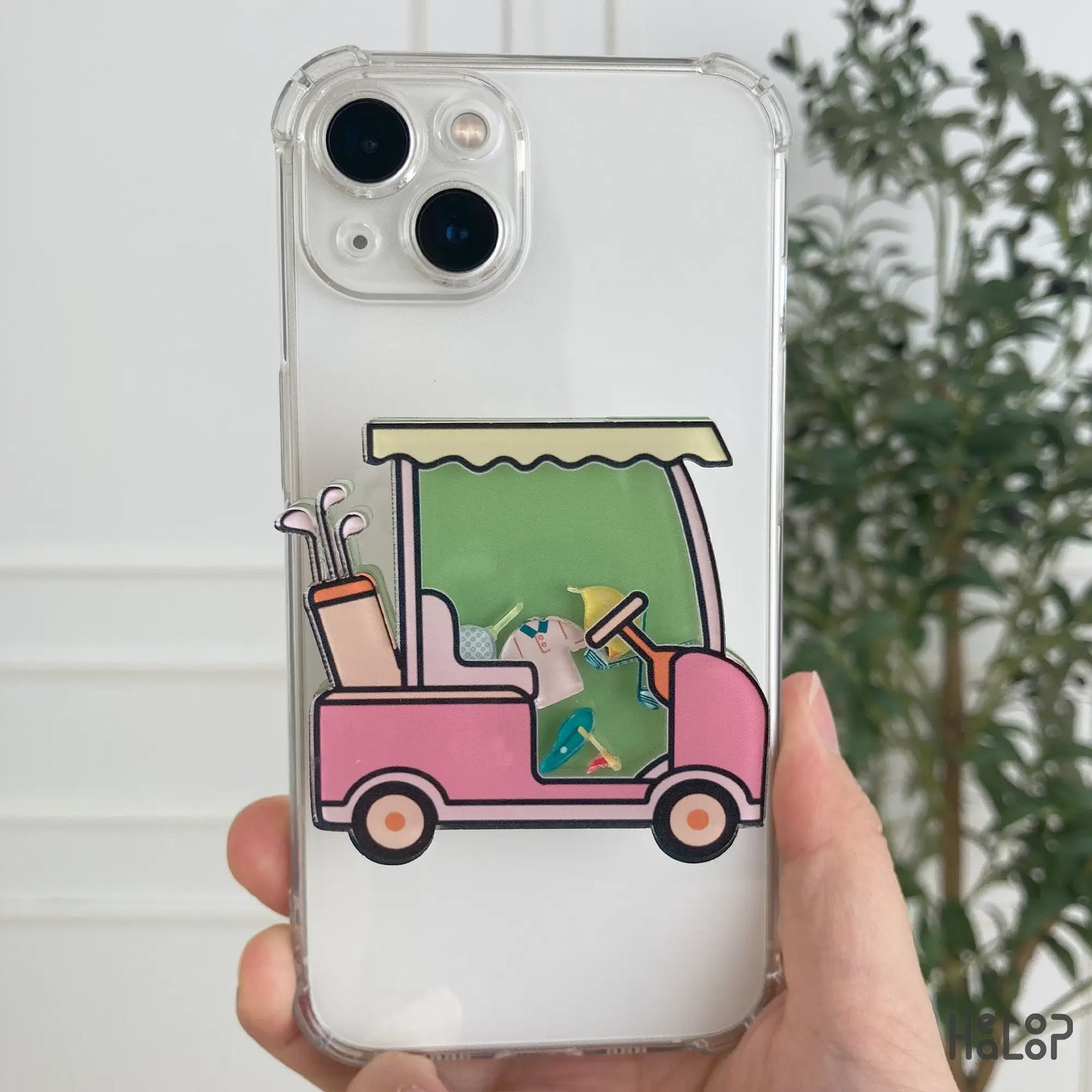 Pink golf cart shaker phone grip attached to clear iPhone case