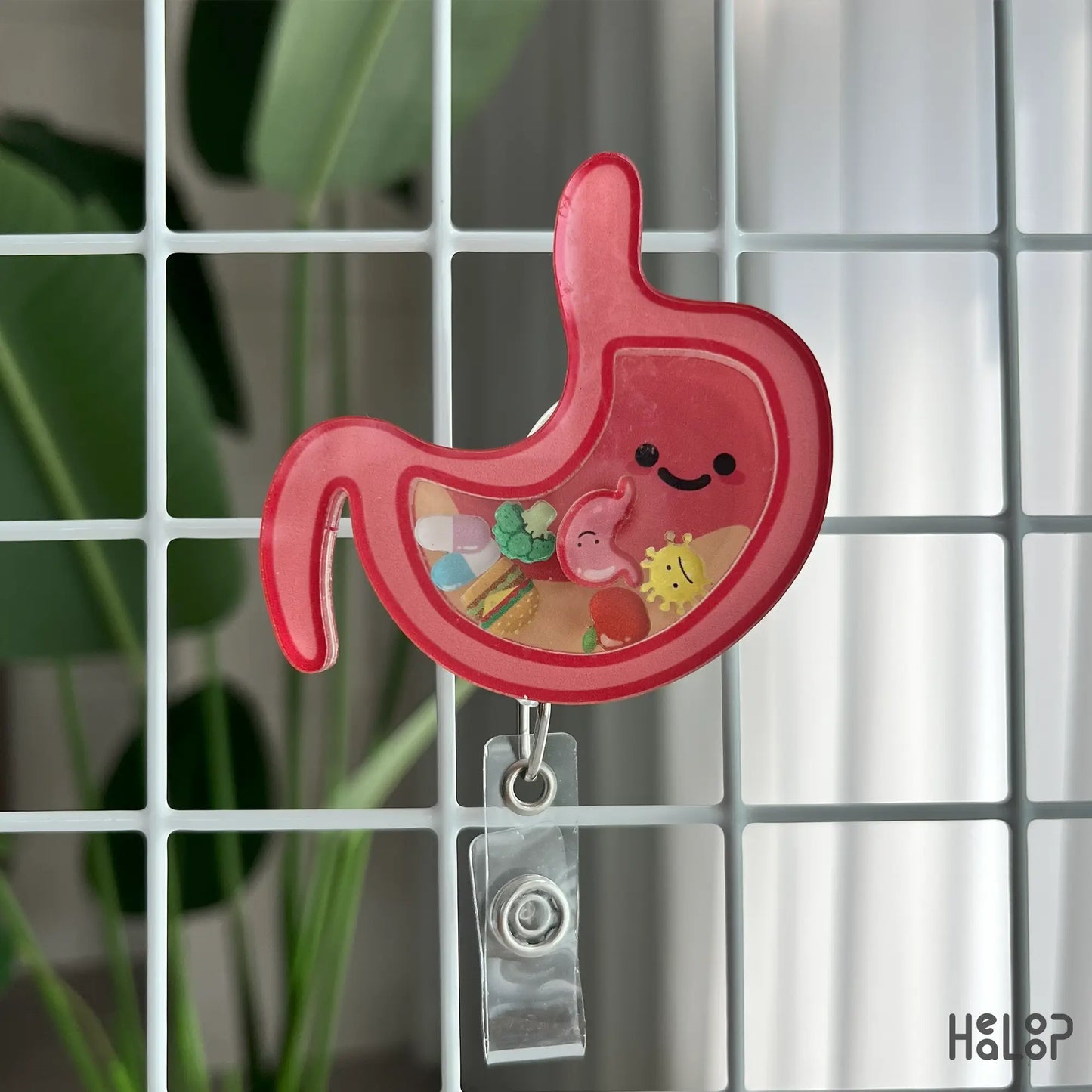 Gastroenterologist stomach badge reel with colorful shaker pieces, displayed on grid background
