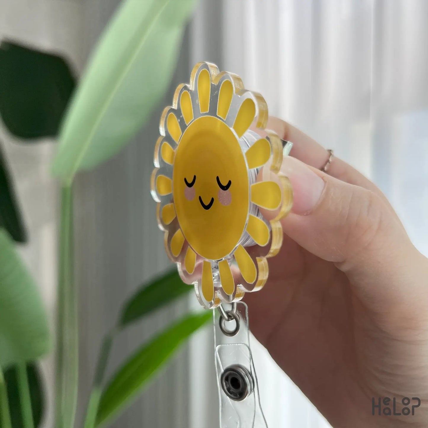 Clear acrylic sunshine badge reel side view, durable retractable ID reel.