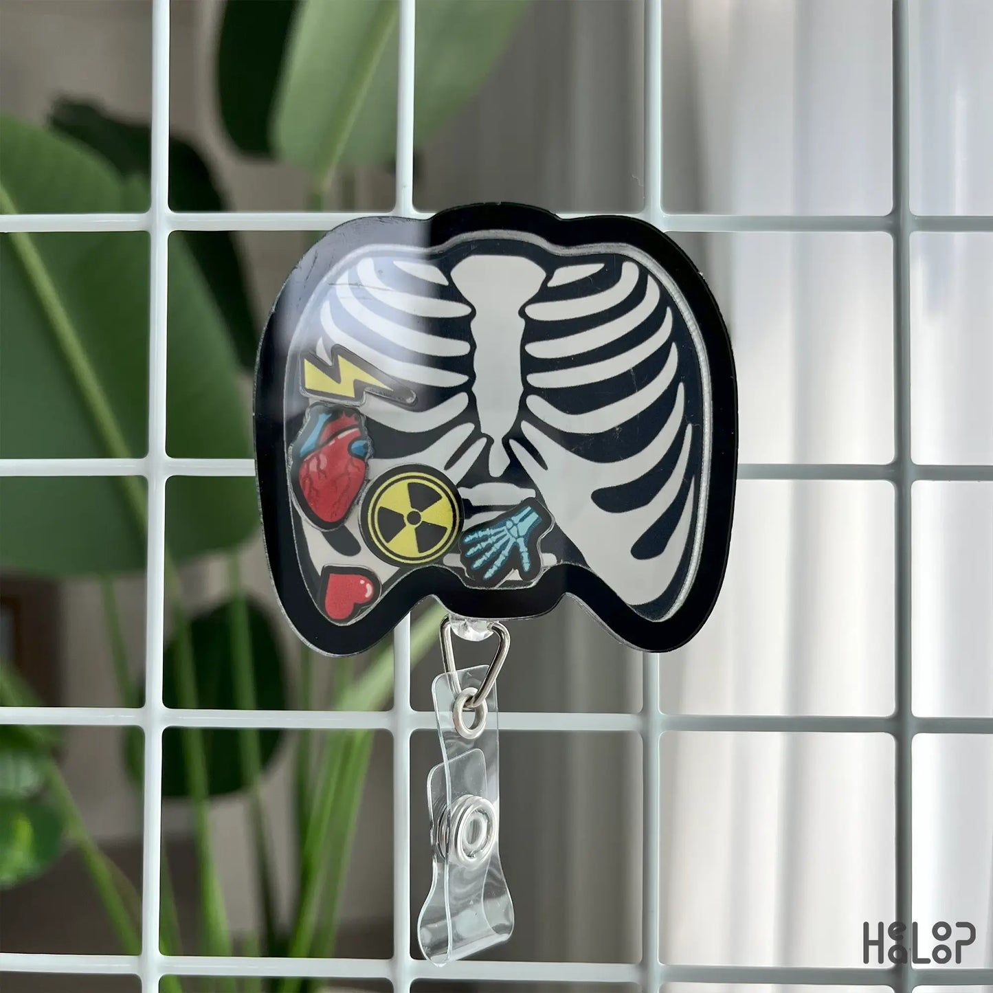 X-Ray tech badge reel with ribcage design and fun shaker charms, perfect for nurses and rad techs