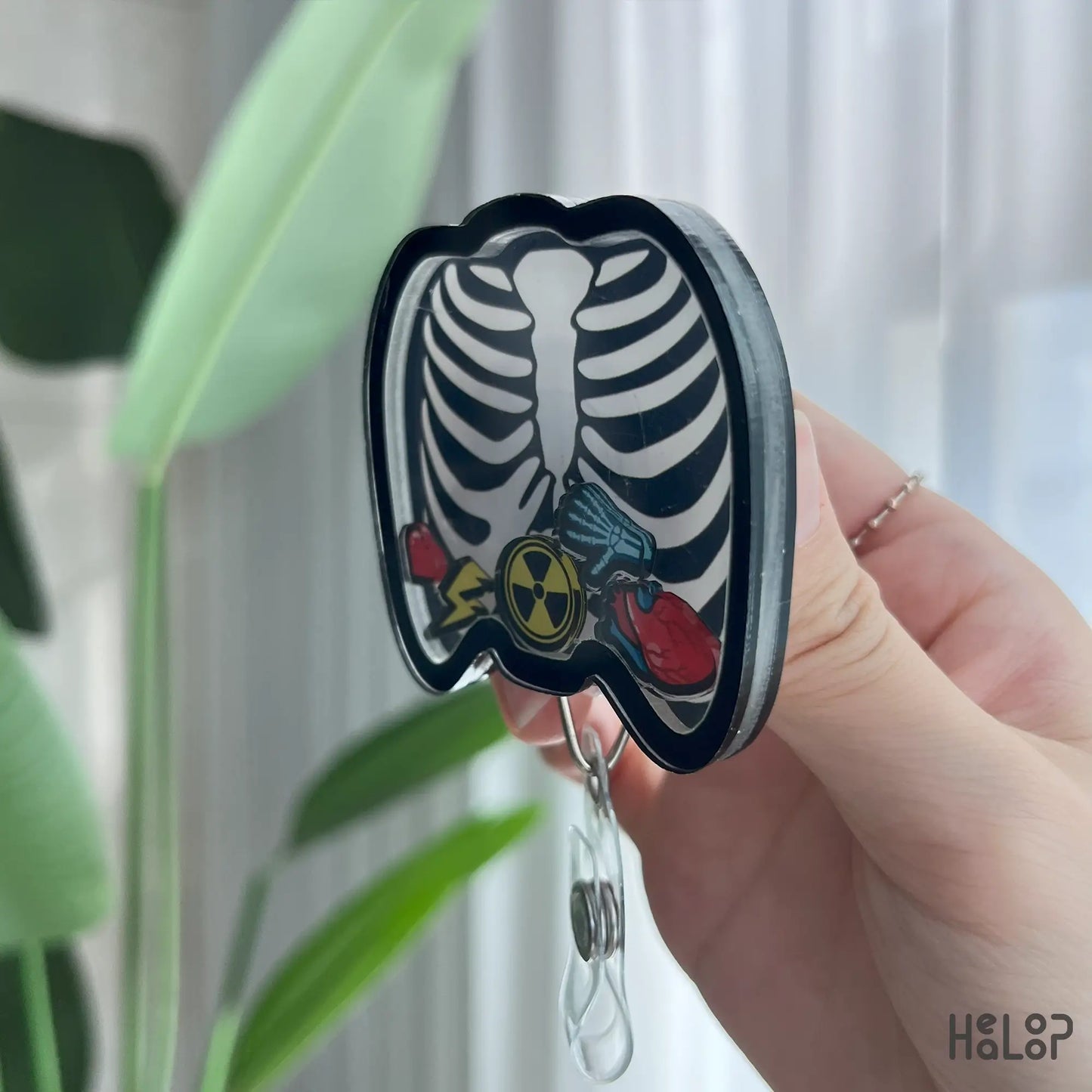 Acrylic X-Ray badge reel side view showing ribcage details and floating charms