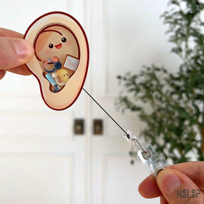 Retractable audiologist badge reel with ear design
