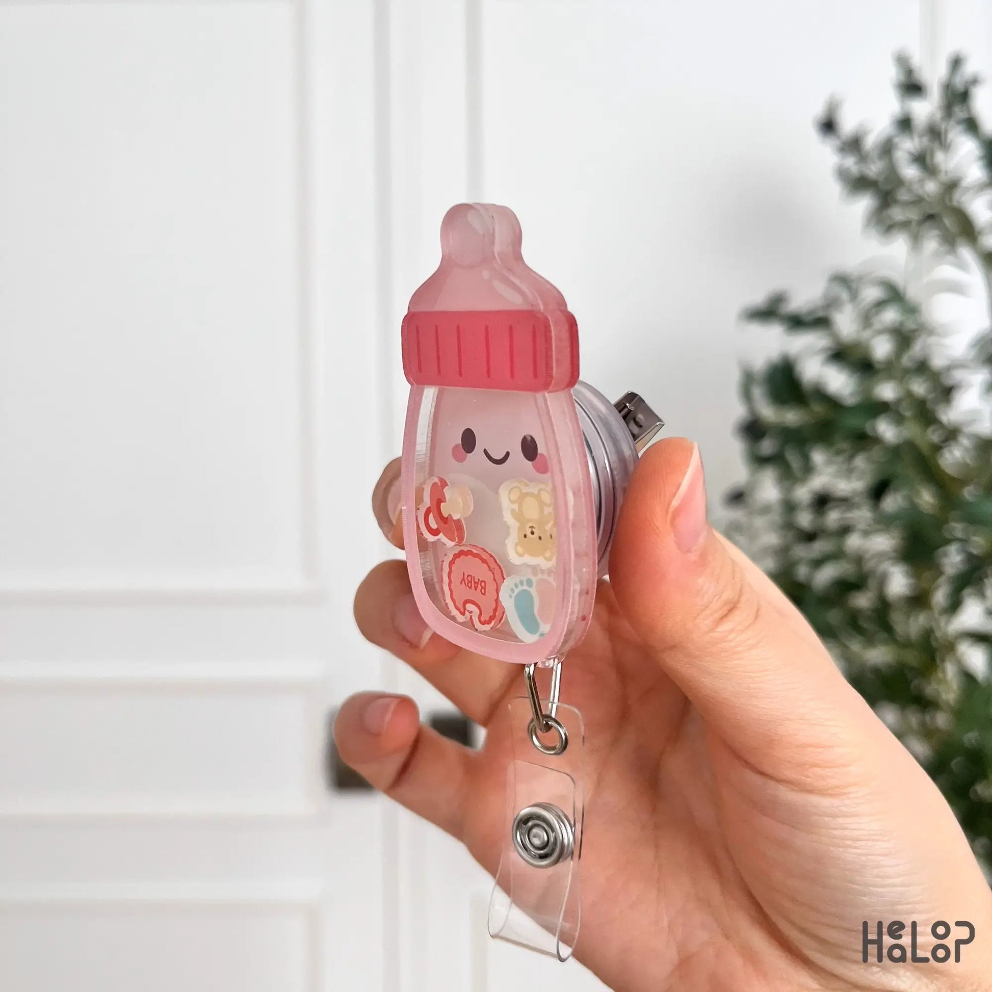 Acrylic baby bottle badge reel side profile showing shaker design