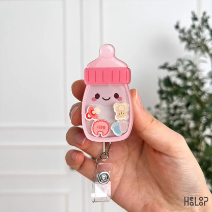 Baby bottle shaker badge reel with baby themed charms and acrylic badge holder