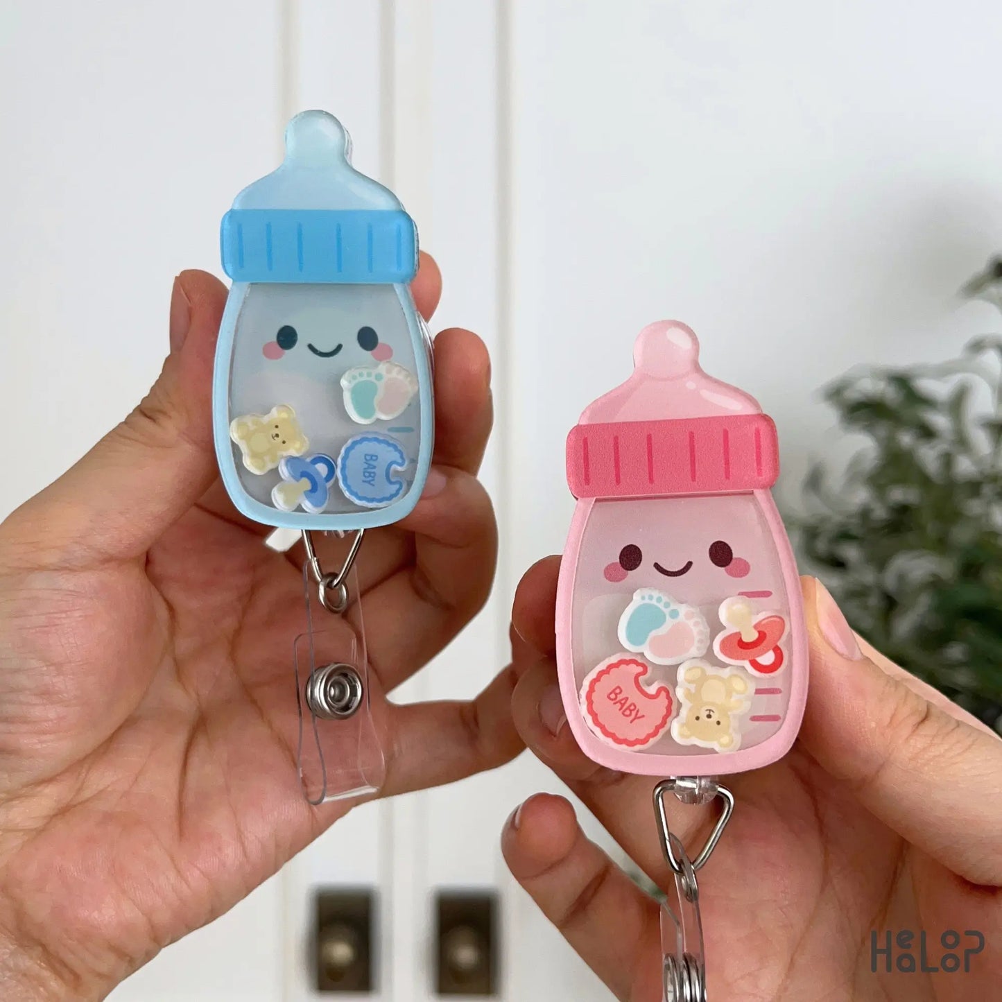 Cute pink and blue Baby Bottle Shaker Badge Reels with baby themed charms and retractable badge holders