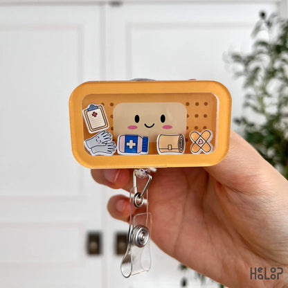 Front close-up of cute bandage shaker badge reel with nurse-themed charms