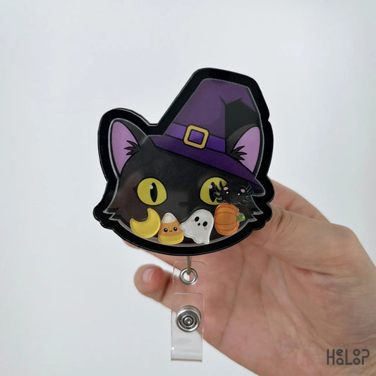 Handmade Black Cat Halloween Shaker Badge Reel featuring a witch hat, ghost, pumpkin, moon, candy corn and spider shaker charms