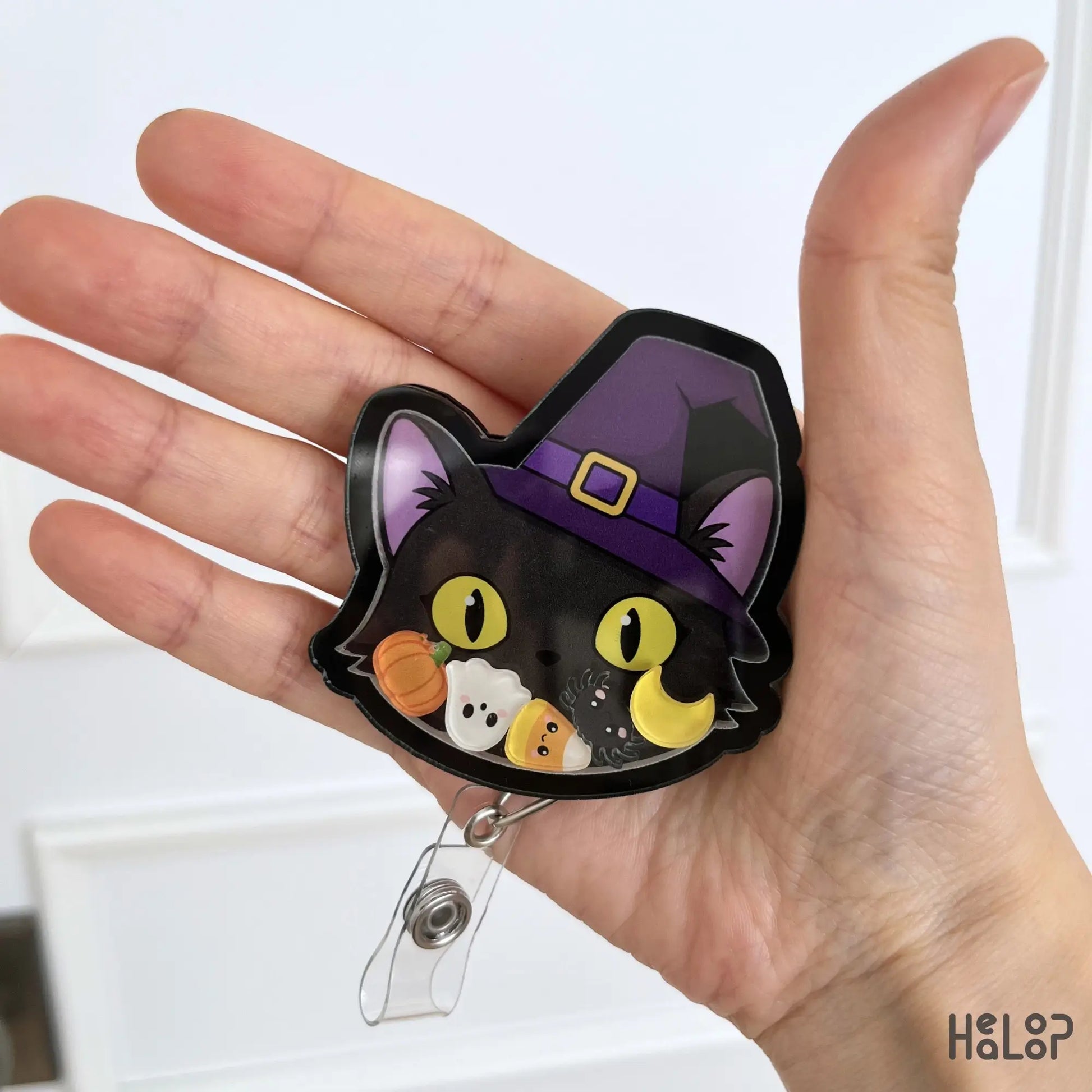 Cute Black Cat Halloween Shaker Badge Reel with witch hat and Halloween shaker charms for nurses, healthcare workers and teachers