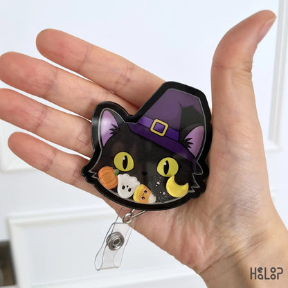 Cute Black Cat Halloween Shaker Badge Reel with witch hat and Halloween shaker charms for nurses, healthcare workers and teachers