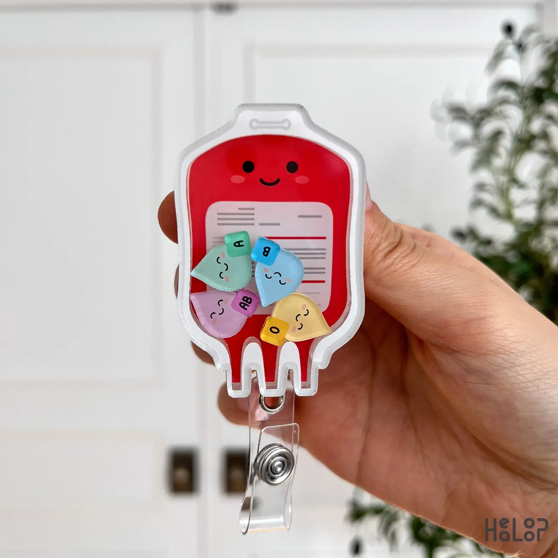 Close-up of blood bag shaker badge reel with cute ABO blood type charms for nurses