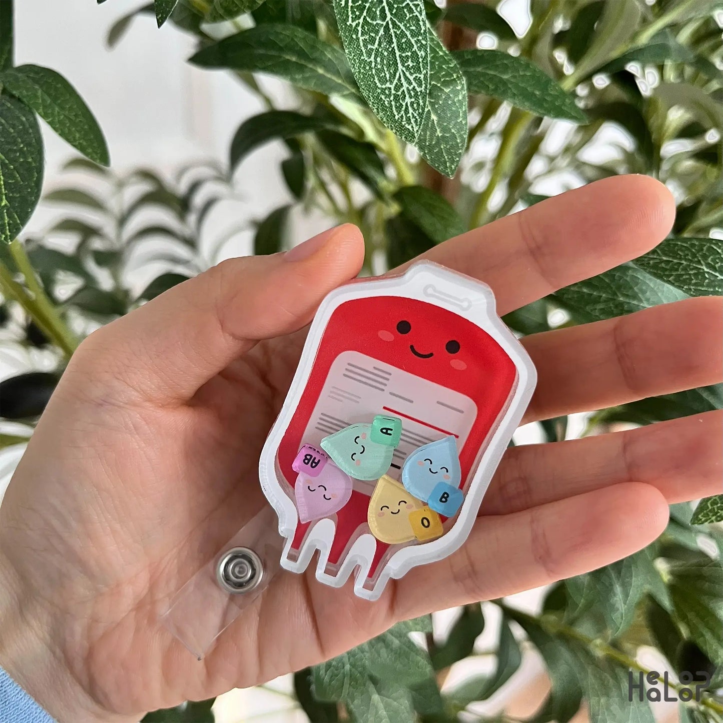 Blood bag shaker badge reel with smiling face and ABO charms for medical ID badges