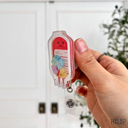 Side view of acrylic layered blood bag shaker badge reel with movable charms