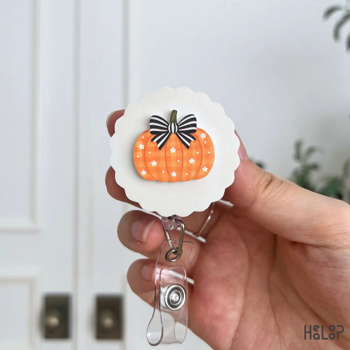 Fall pumpkin badge reel with black and white striped bow and floral pattern