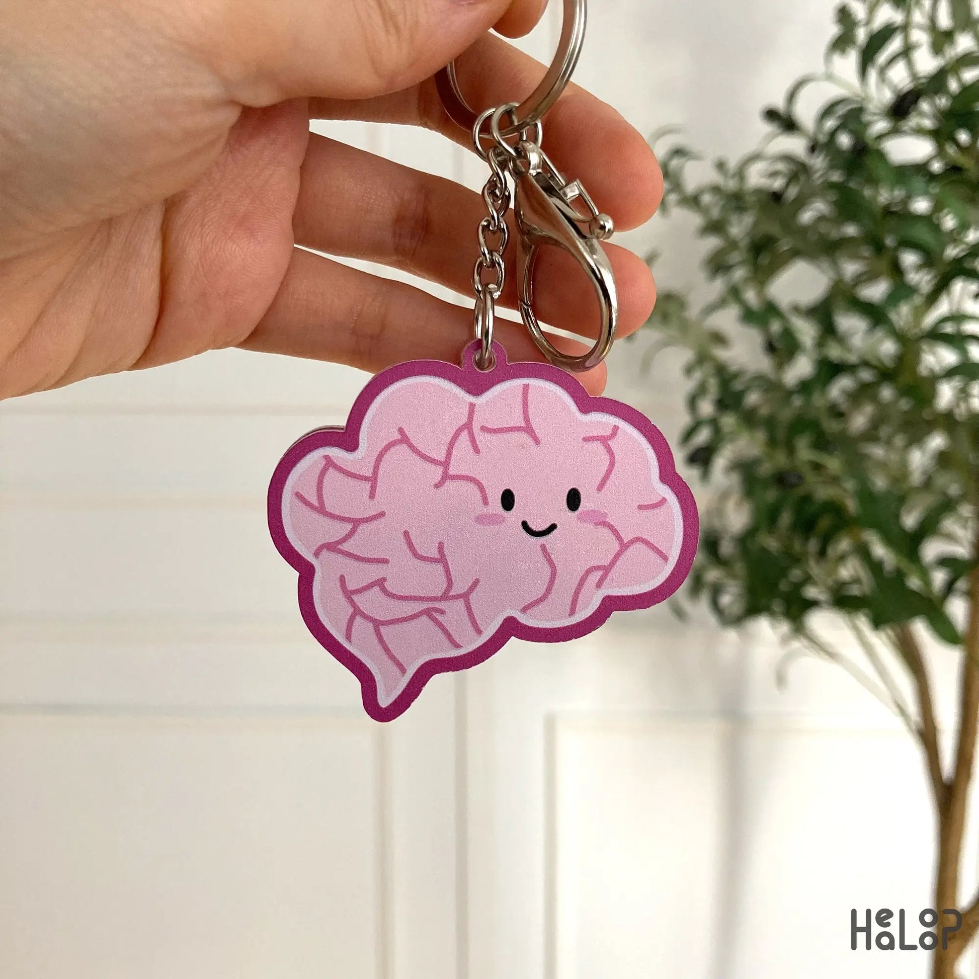 Backside illustration of adorable pink brain keychain.