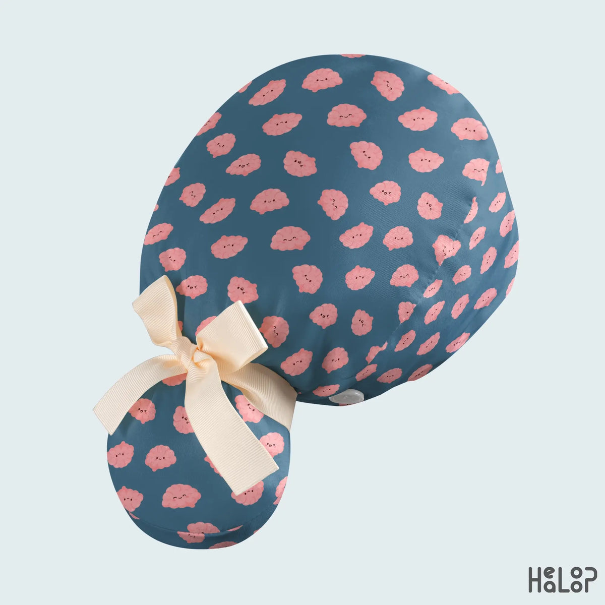 Brain Ponytail Scrub Cap angled back view showing playful pink brain prints, a cream-colored ribbon tie, and a roomy ponytail pouch for long hair.