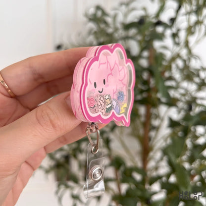 Side angle of shaker badge reel with mini brain and sparkle charms