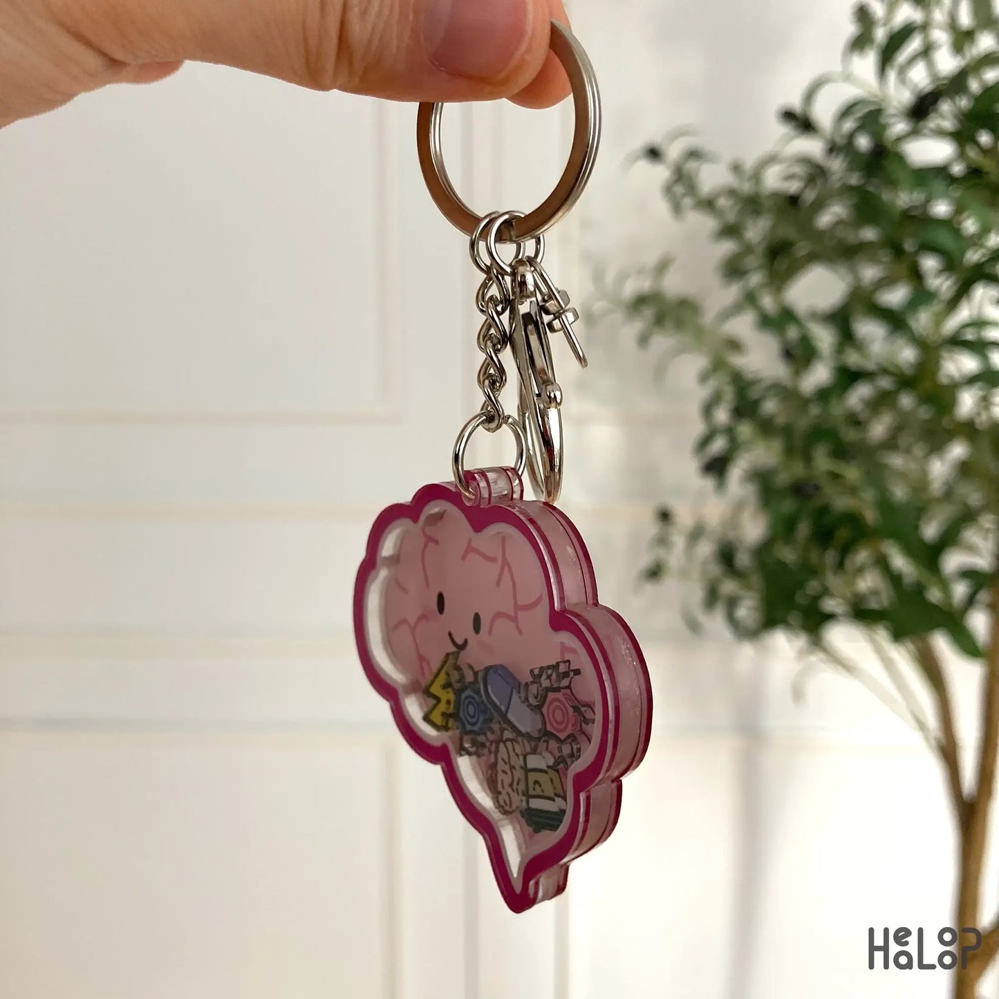Side angle of acrylic brain keychain showing layered structure.