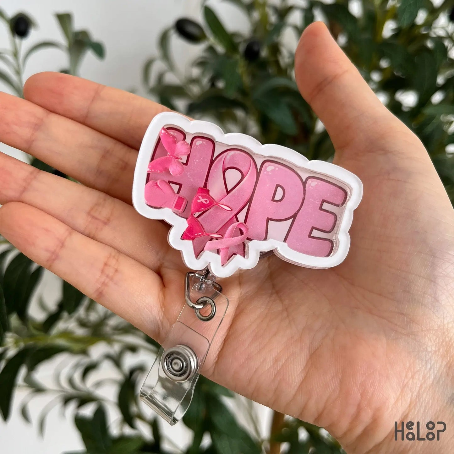 Breast Cancer Hope Shaker Badge Reel featuring a pink awareness ribbon and movable pink shaker charms for oncology nurses and breast cancer supporters.
