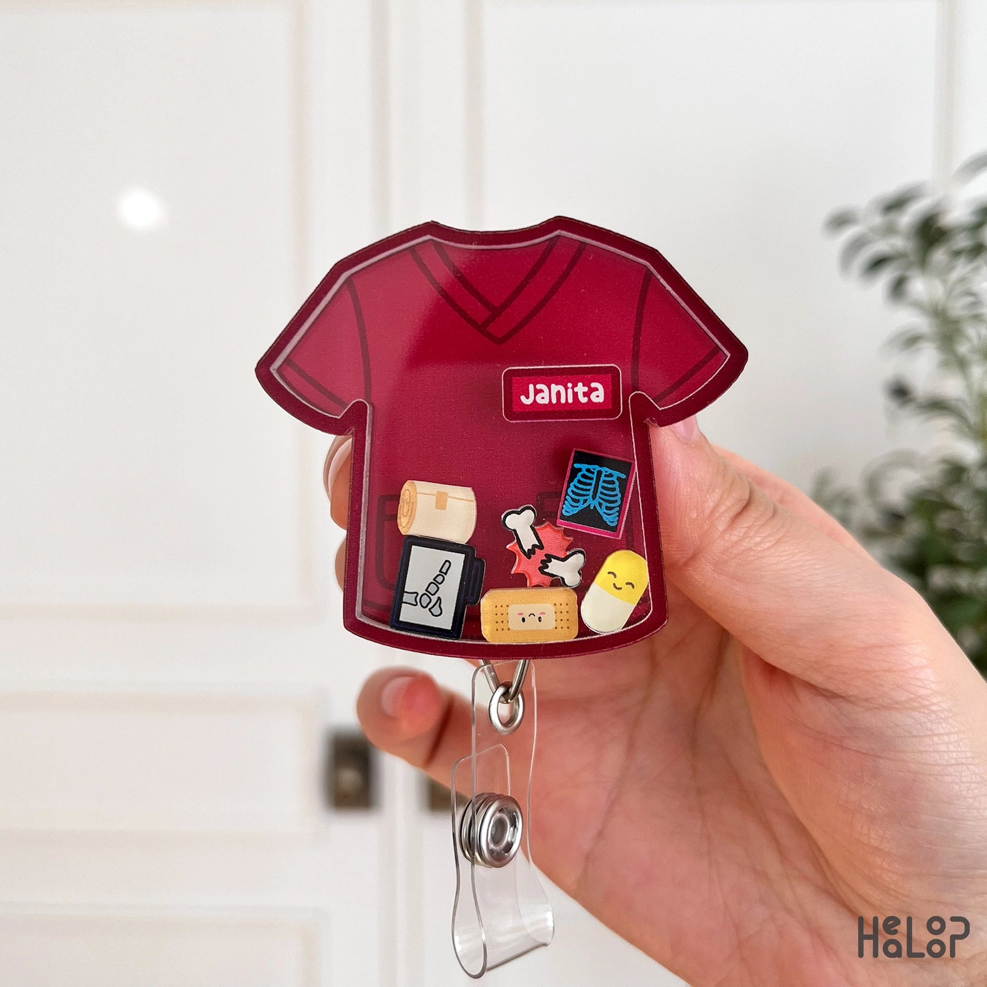 burgundy nurse scrub badge reel with name janita and medical themed charms personalized badge reel