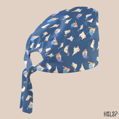 Cat Classic Scrub Cap in an angled side view, highlighting the cute cat and yarn ball pattern, classic scrub cap silhouette, and adjustable back ties.