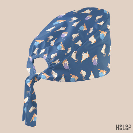 Cat Classic Scrub Cap in an angled side view, highlighting the cute cat and yarn ball pattern, classic scrub cap silhouette, and adjustable back ties.
