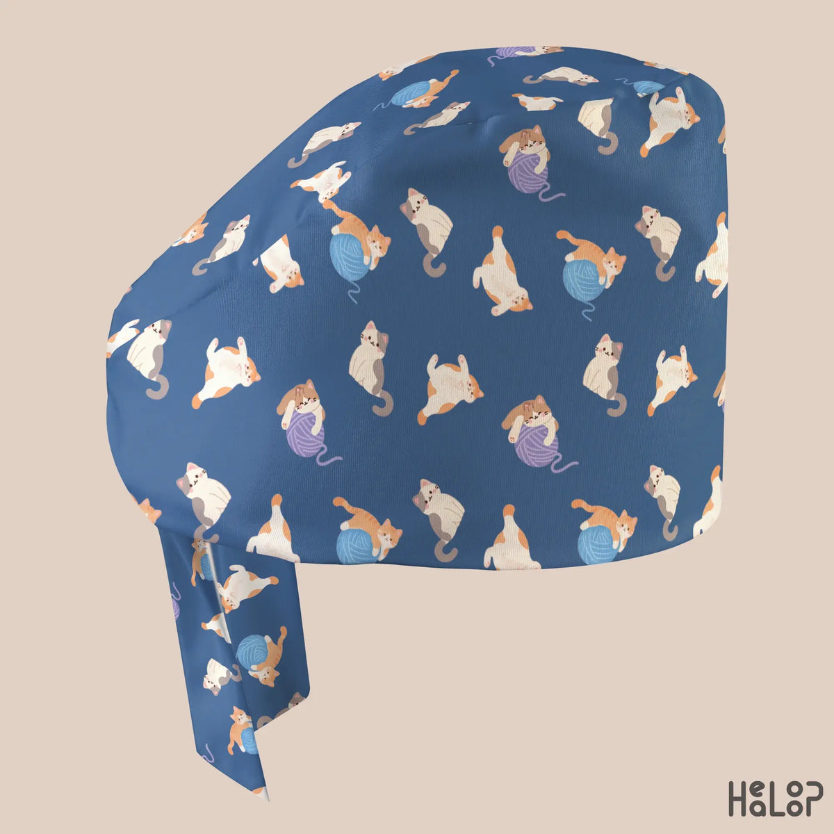 Side profile of the HEALOOP Cat Classic Scrub Cap featuring orange, white, and gray cats playing with blue and purple yarn balls on a navy blue background.