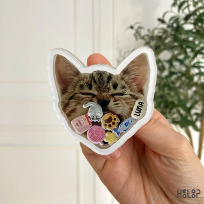 Close-up of custom pet shaker phone grip featuring cat photo and acrylic charms