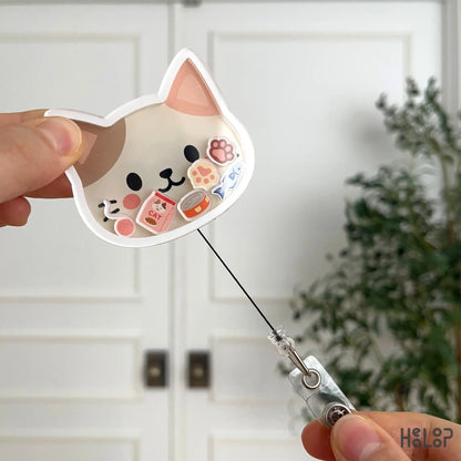 Retractable cat badge reel demonstrating smooth pull cord and lightweight acrylic design