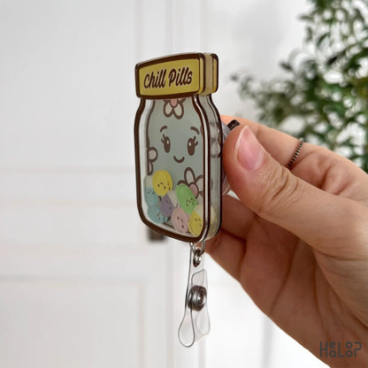 Side view of Healoop Chill Pills Shaker Badge Reel showing acrylic thickness and clip