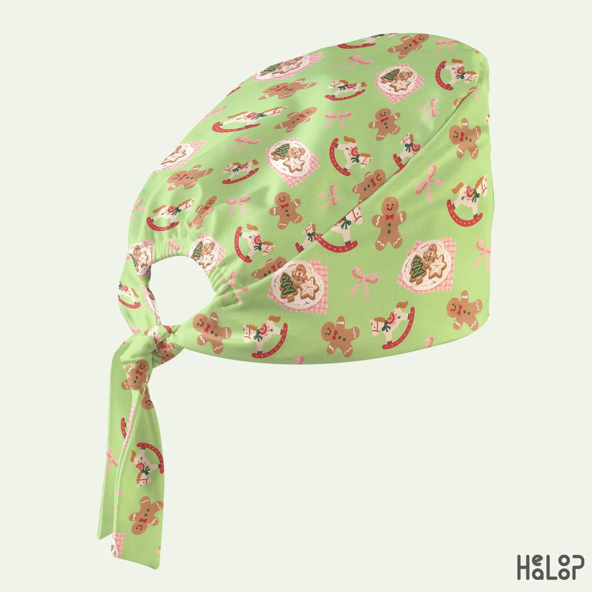 Christmas Classic Scrub Cap in green featuring gingerbread men, rocking horses, Christmas cookies and pink bows, side view with adjustable back ties.