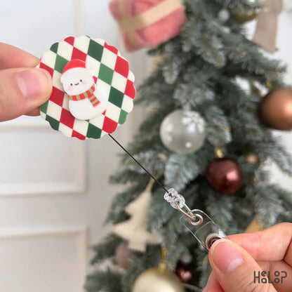 Retractable Christmas Snowman ID Badge Holder with red and green argyle background and extended badge reel cord