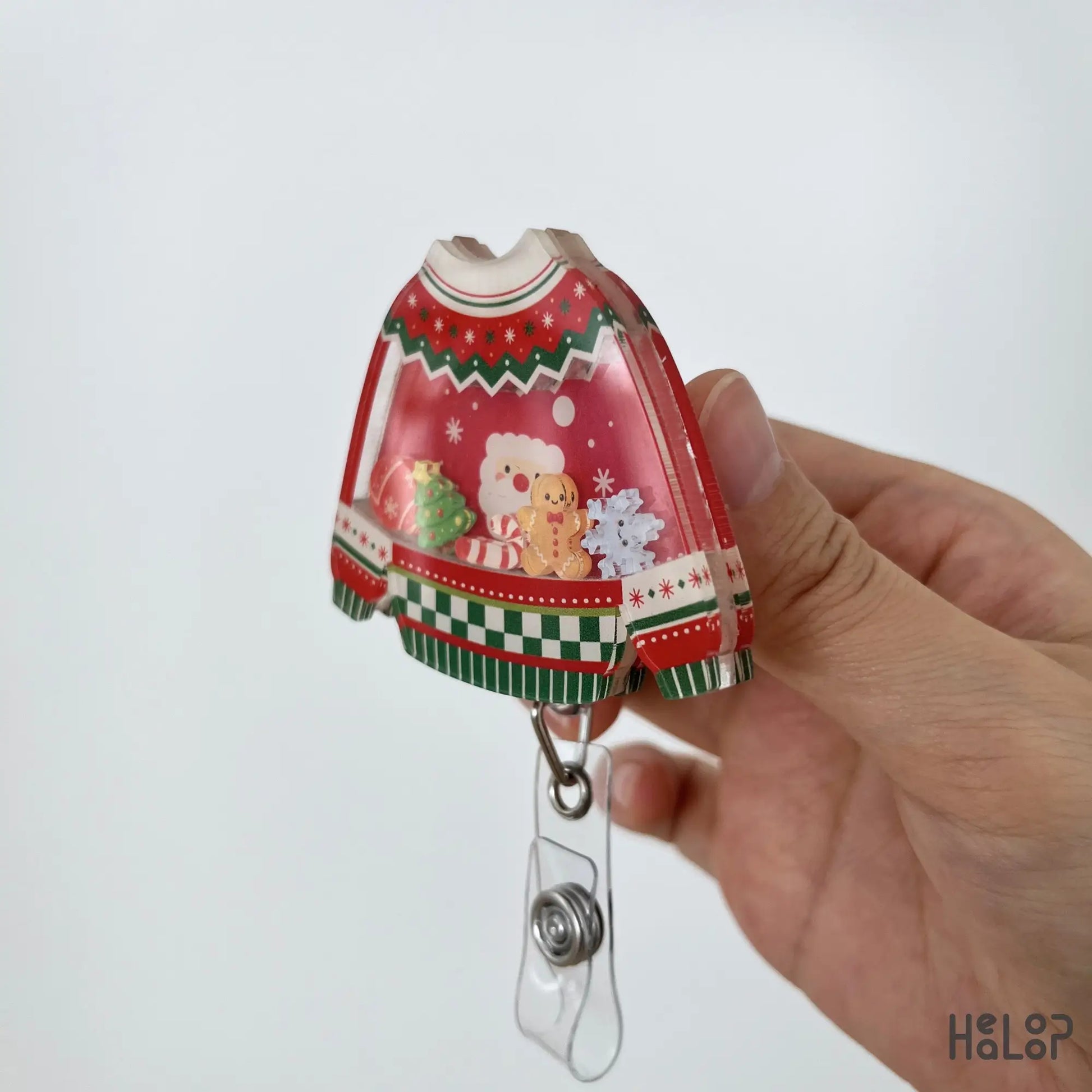 Layered acrylic Christmas Ugly Sweater Shaker Badge Reel shown from the side