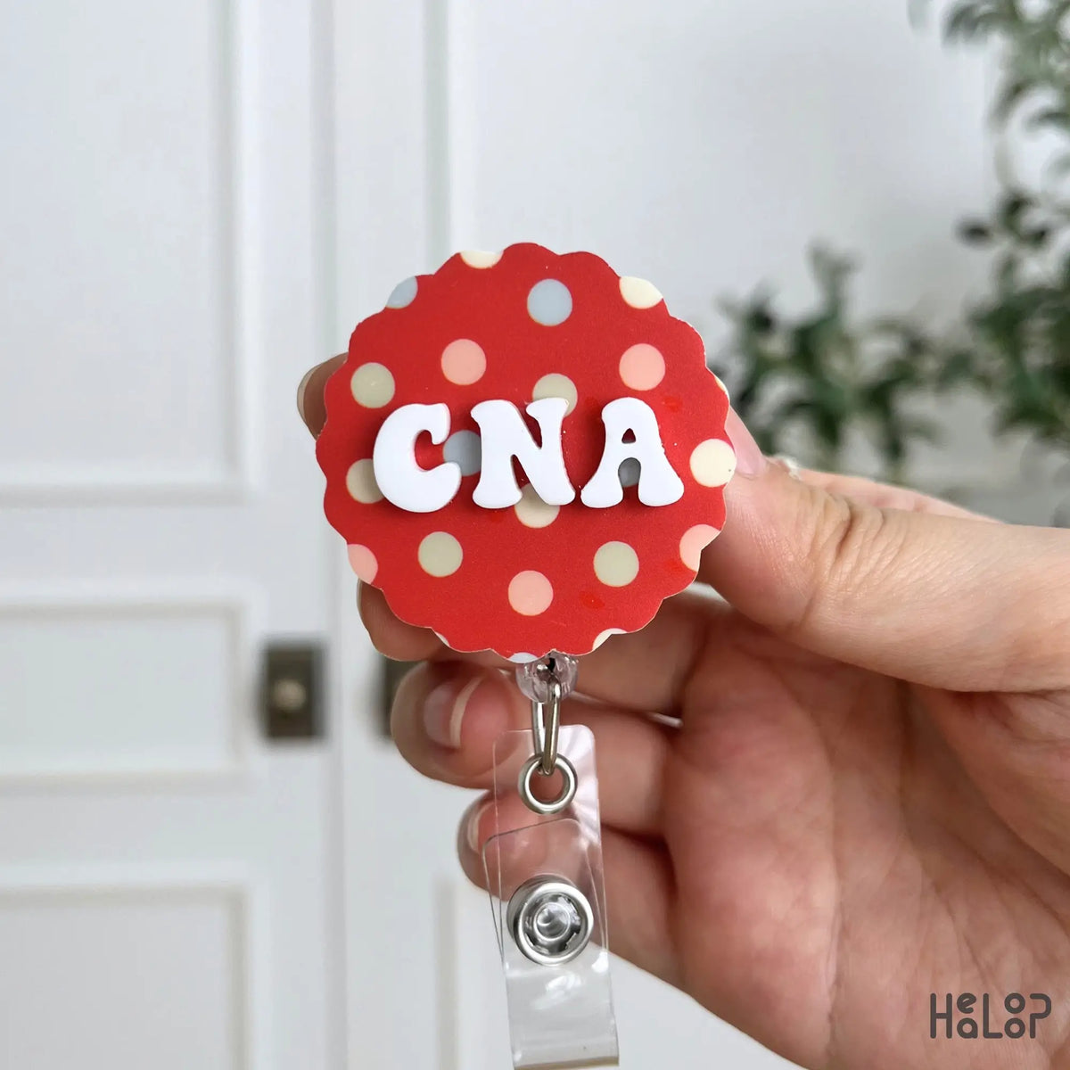 CNA badge reel with raised white custom letters and colorful polka dot background for nursing and healthcare workers