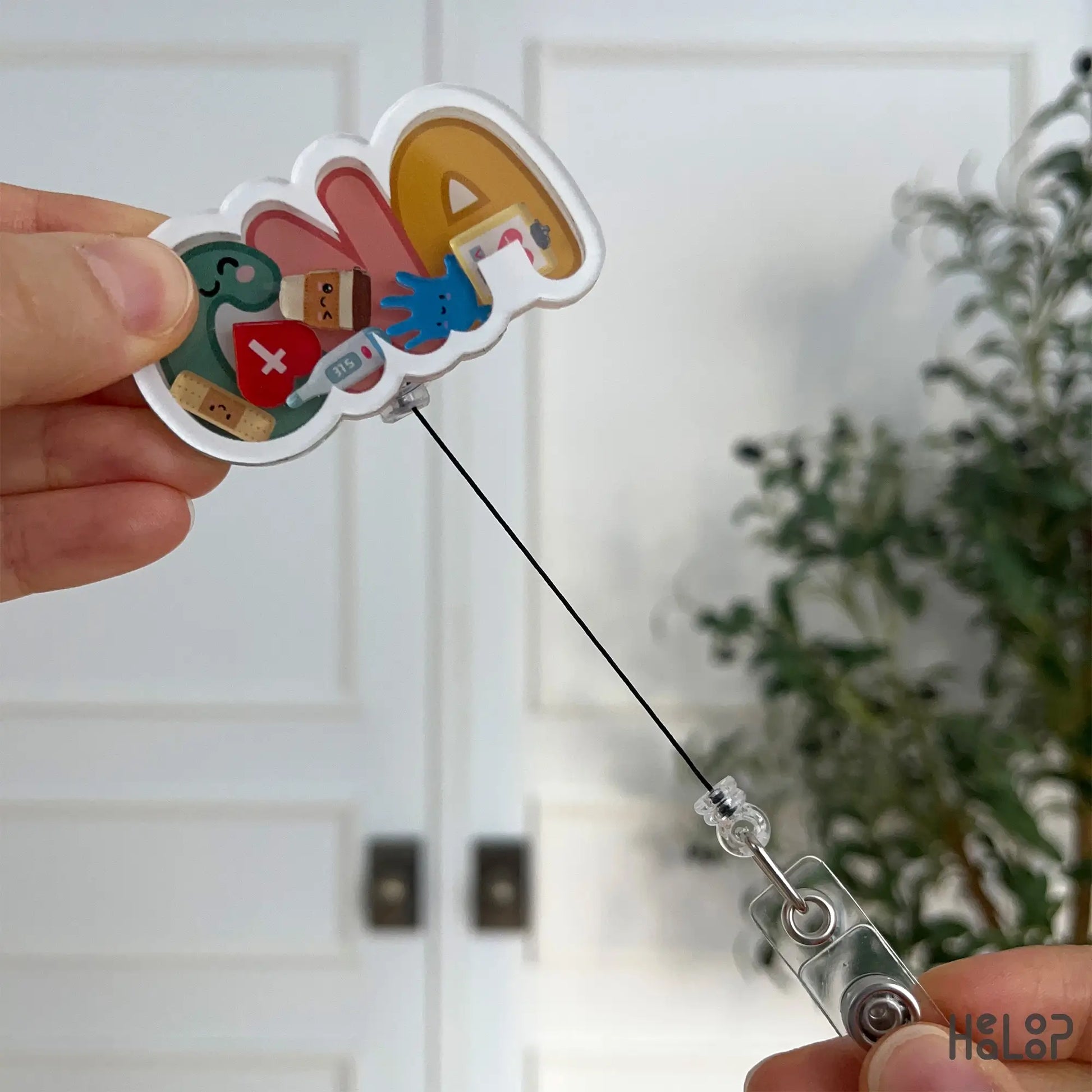 CNA shaker badge reel shown with fully extended retractable cord for easy scanning.