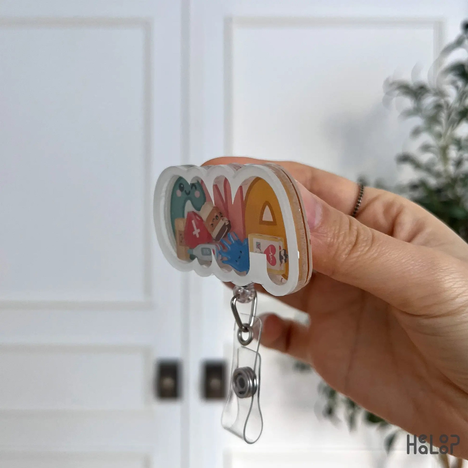 Layered acrylic side profile of the CNA shaker badge reel highlighting depth and clarity.