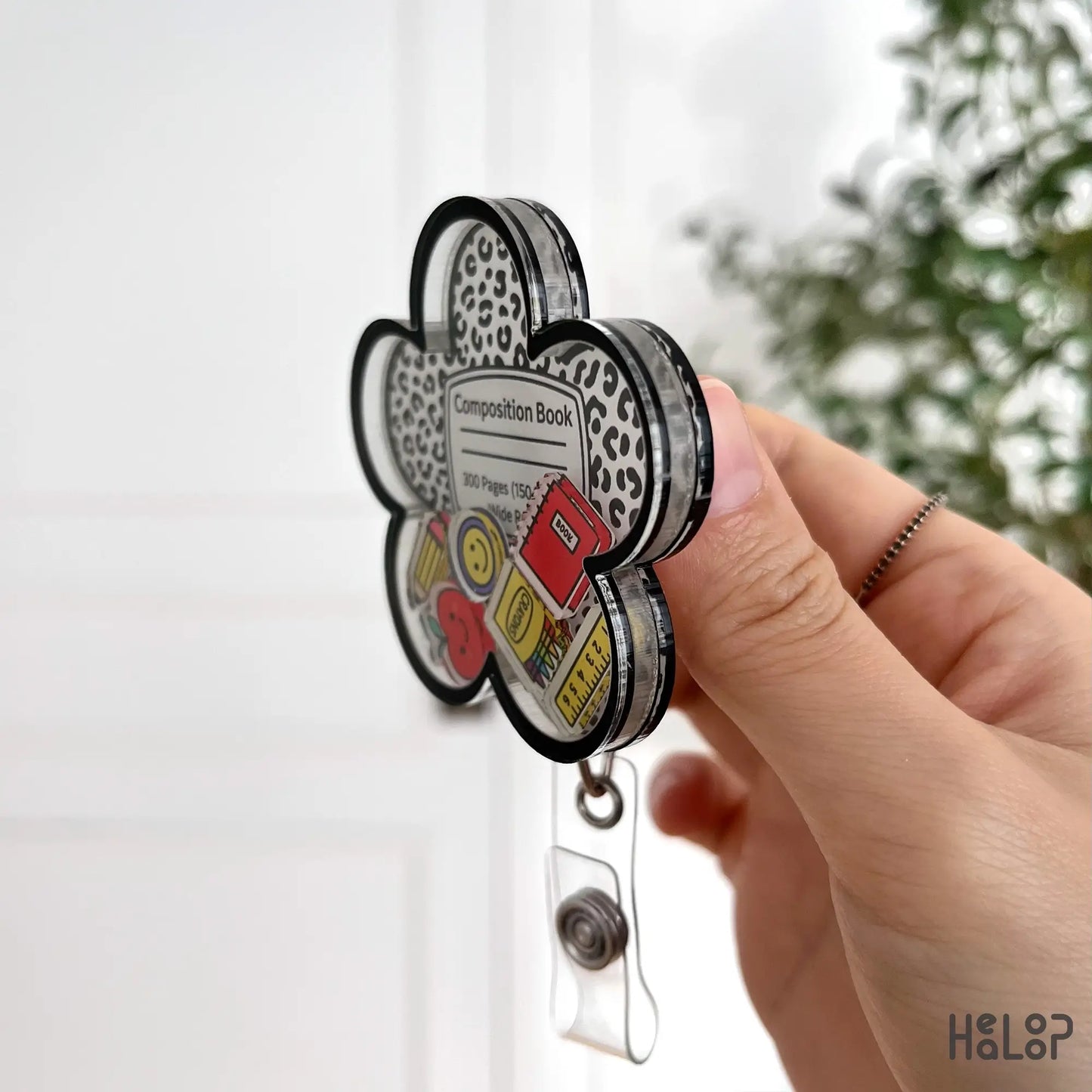 shaker badge reel side angle showing layered acrylic structure and retractable clip