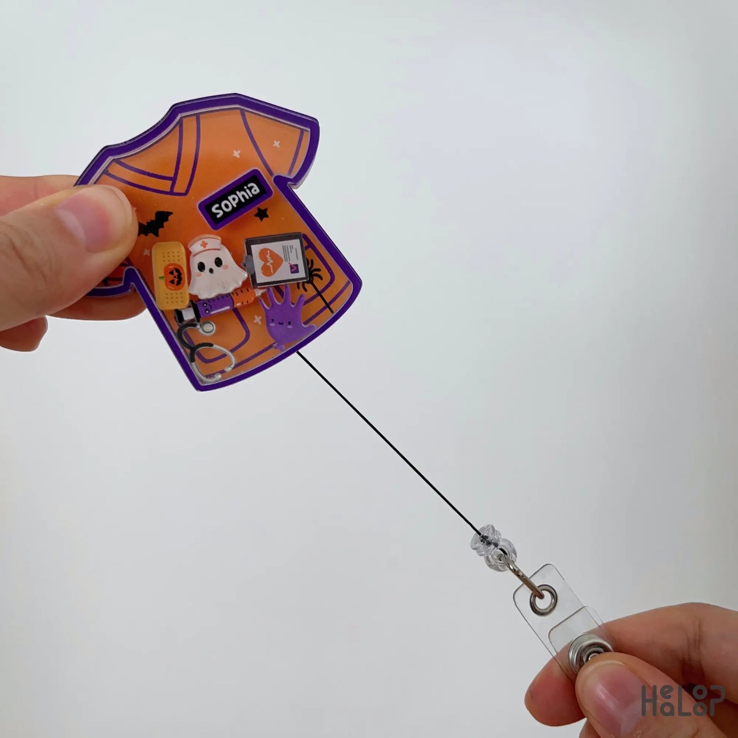 Personalized Halloween nurse shaker badge reel with retractable badge cord and Halloween medical charms.