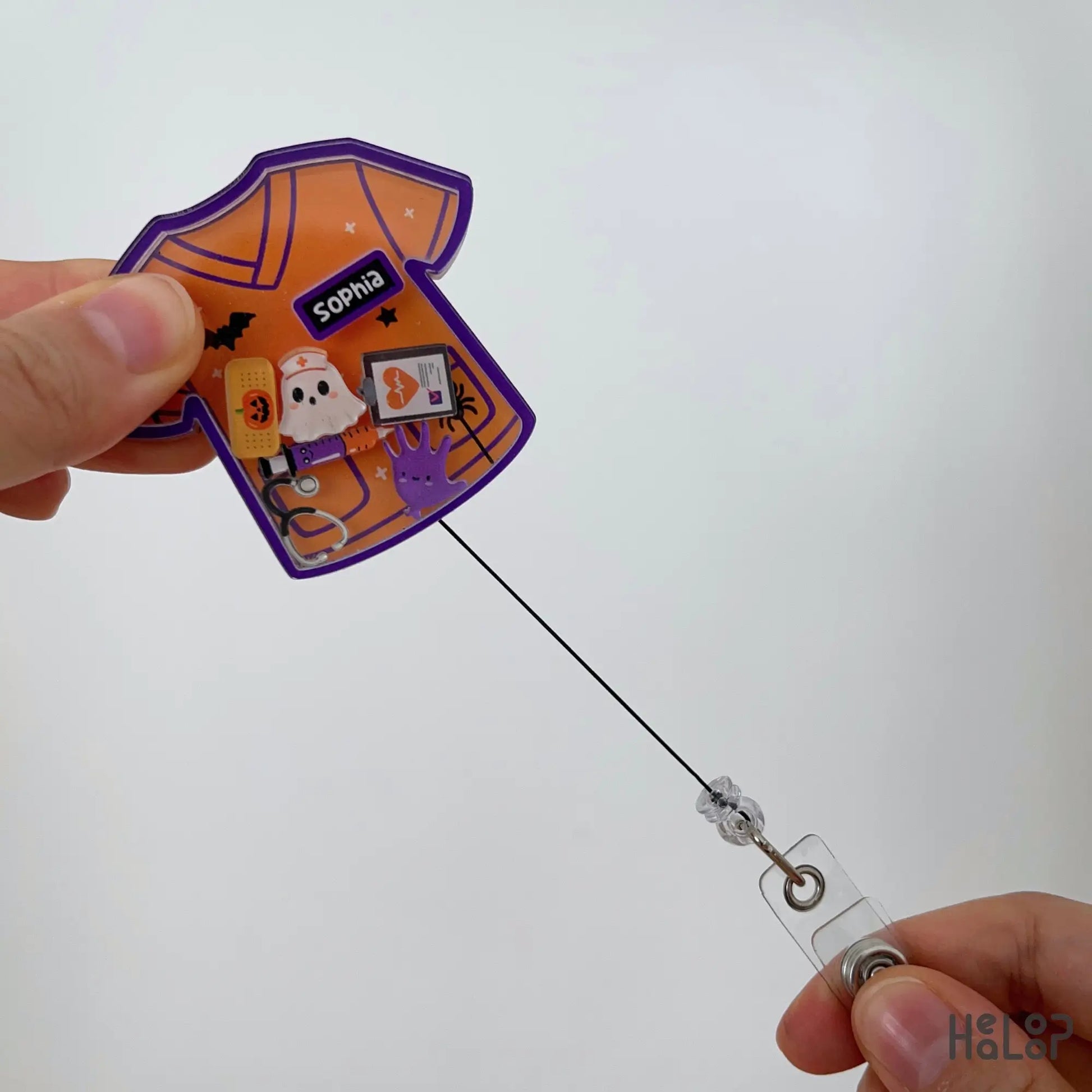 Personalized Halloween nurse shaker badge reel with retractable badge cord and Halloween medical charms.