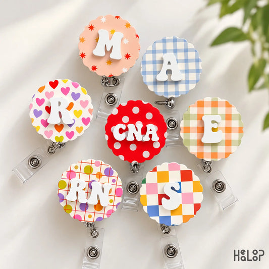 Custom initial and letter badge reels with colorful pattern options including RN and CNA personalized designs