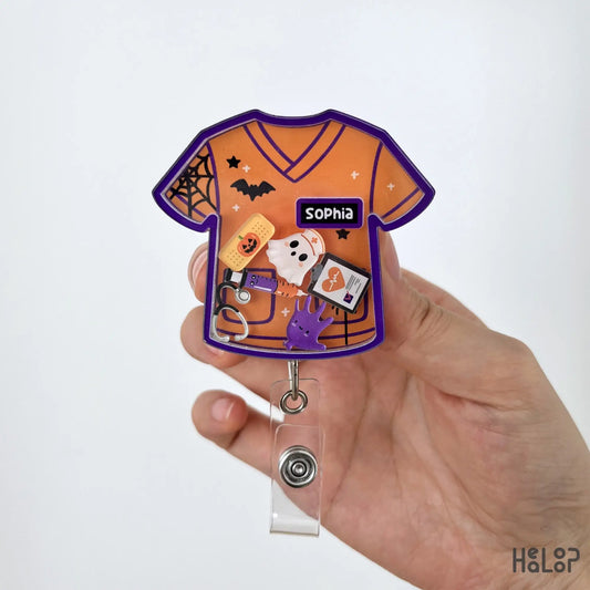 Close-up of a personalized Halloween nurse shaker badge reel with custom name and spooky healthcare charms.
