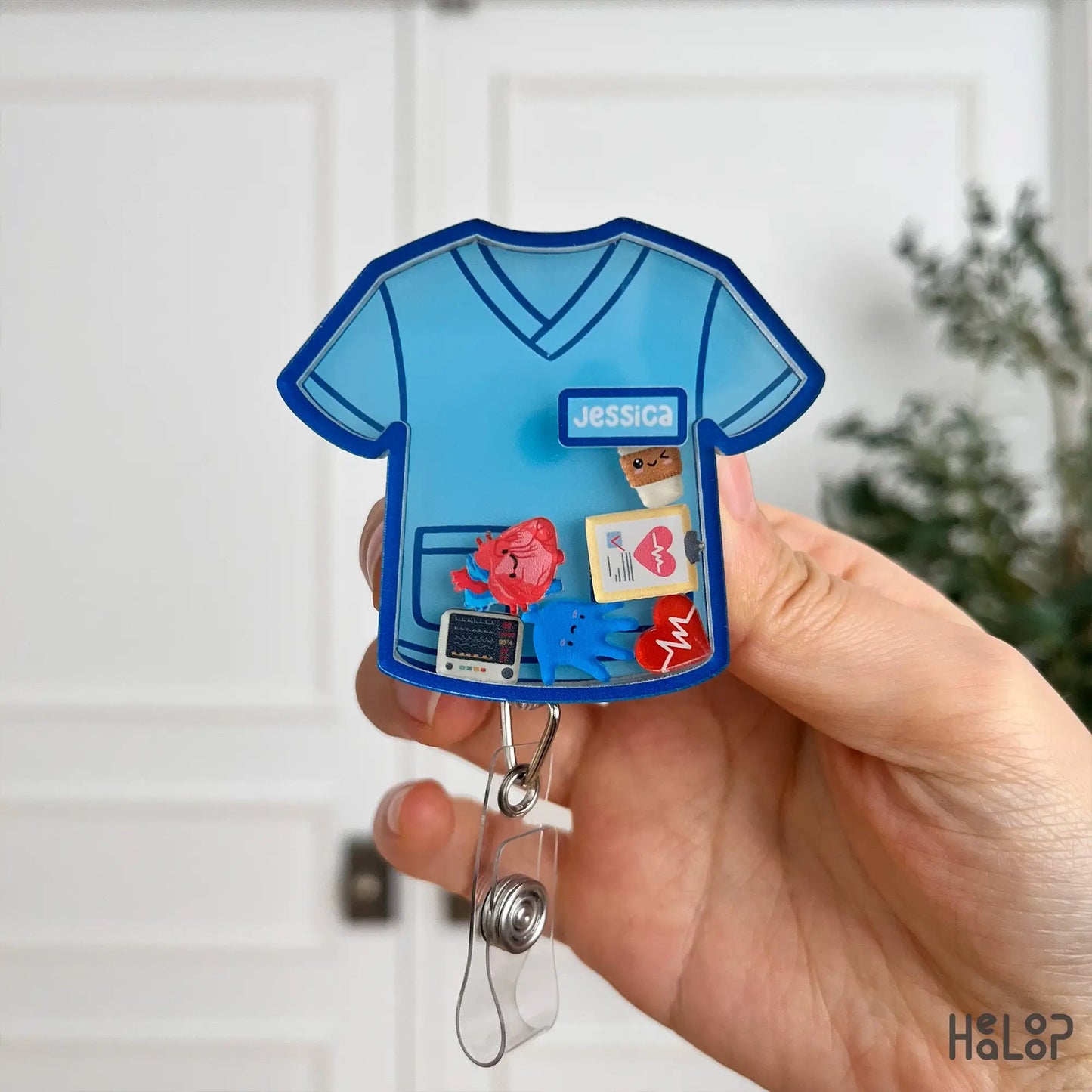 Front view of personalized nurse scrub top badge reel with customizable charms